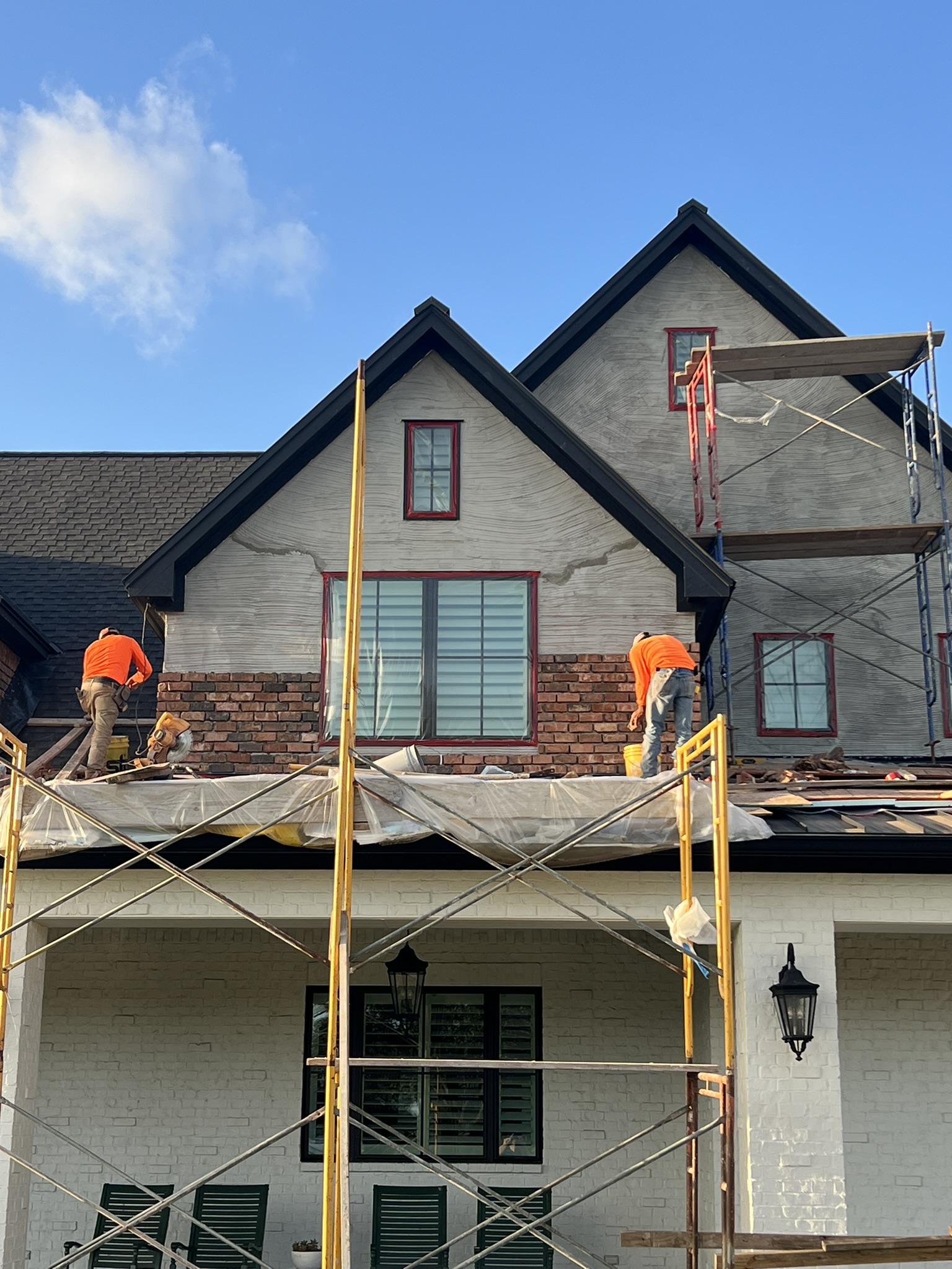 An exterior remodel with brick, stucco, and stone work